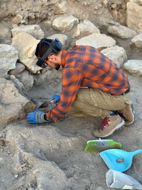 HKU archaeology PhD candidate Mr Hayk Azizbekyan digging on-site while wearing an MR headset and viewing the real world and the previously recorded 3D data. (Photo credit: HKU Faculty of Arts)